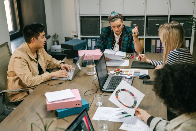 A group of professionals engaged in a planning meeting at the office, showcasing teamwork and collaboration. Before you build a talent agencies planning template, fix the scope
