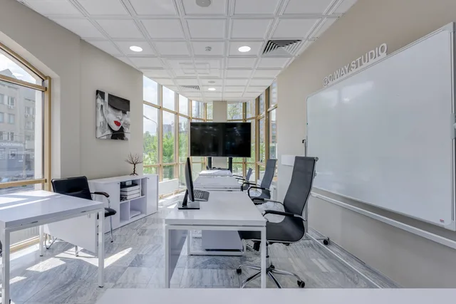 Spacious modern office interior featuring desks, office chairs, large windows, and a whiteboard. How to build a talent agencies quality checklist without gaps