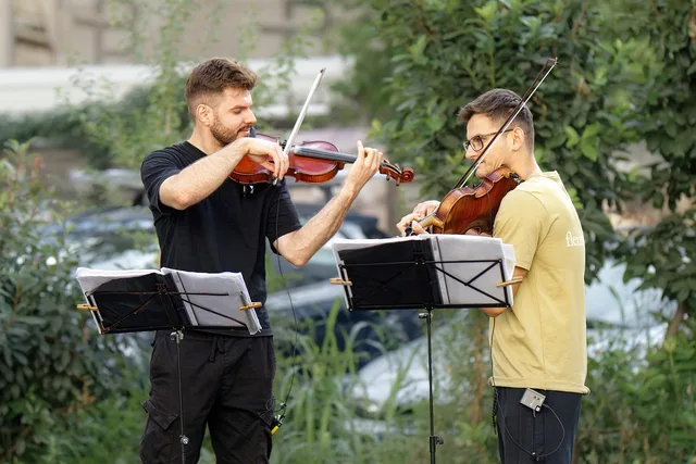 men, violinists, buskers, playing, violin, outdoors, public, attraction, tourism, talent, musical, performers. Talent agencies service standards to publish for clients and creators