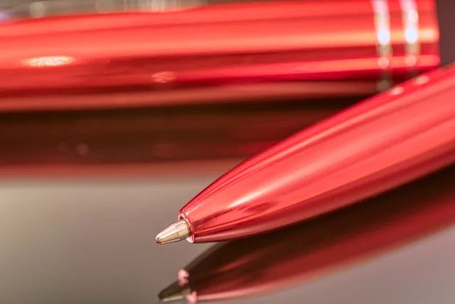 ballpoint pen, writing tool, top, reflection, smooth, red. Talent agency exclusivity clauses: a UK signing checklist