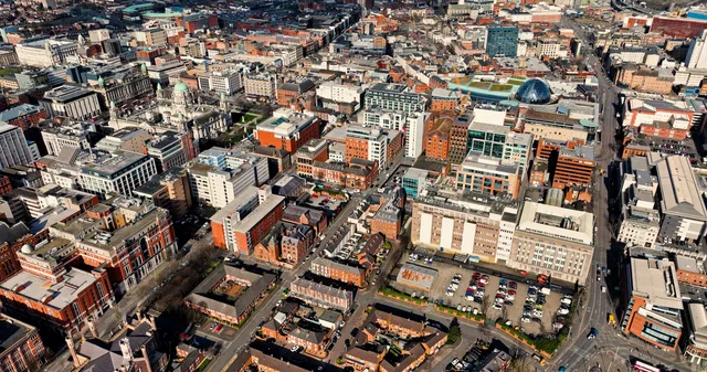 Aerial view showcasing the architectural skyline of Belfast city center in Northern Ireland. Belfast talent management contracts for Irish brands